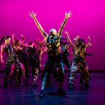 Centre for Advanced Training, dancing group in front of a dramatic magenta backdrop